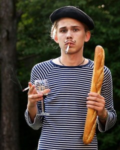 Typical French citizen holding 300 ml glass of wine with 1 meter long baguette and smoking 100 mm cigarette. He'll probably live to be 100 years old....